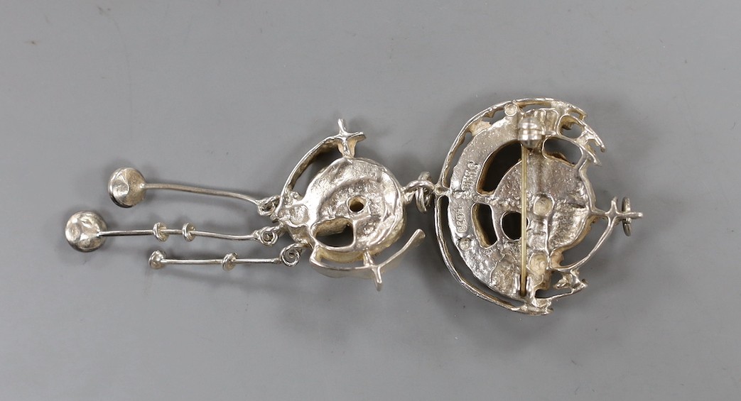 A suite of Norwegian 925s jewellery by Juhls Kautokeino, comprising a pendant brooch, 92mm, pair of drop earrings and a dress ring and one other dress ring by Juhls.